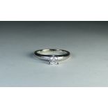 An 18ct white gold solitaire diamond ring set with a circular brilliant cut diamond weighing 0.