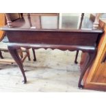 A reproduction mahogany occasional table on cabriole legs