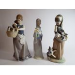 Three Lladro porcelain figurines of girls two holding baskets of puppies and kittens