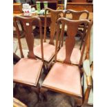 A set of four Edwardian mahogany high backed dining chairs on cabriole legs with pink upholstered