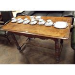 A French fruitwood plank top dining table on turned legs with refectory style base