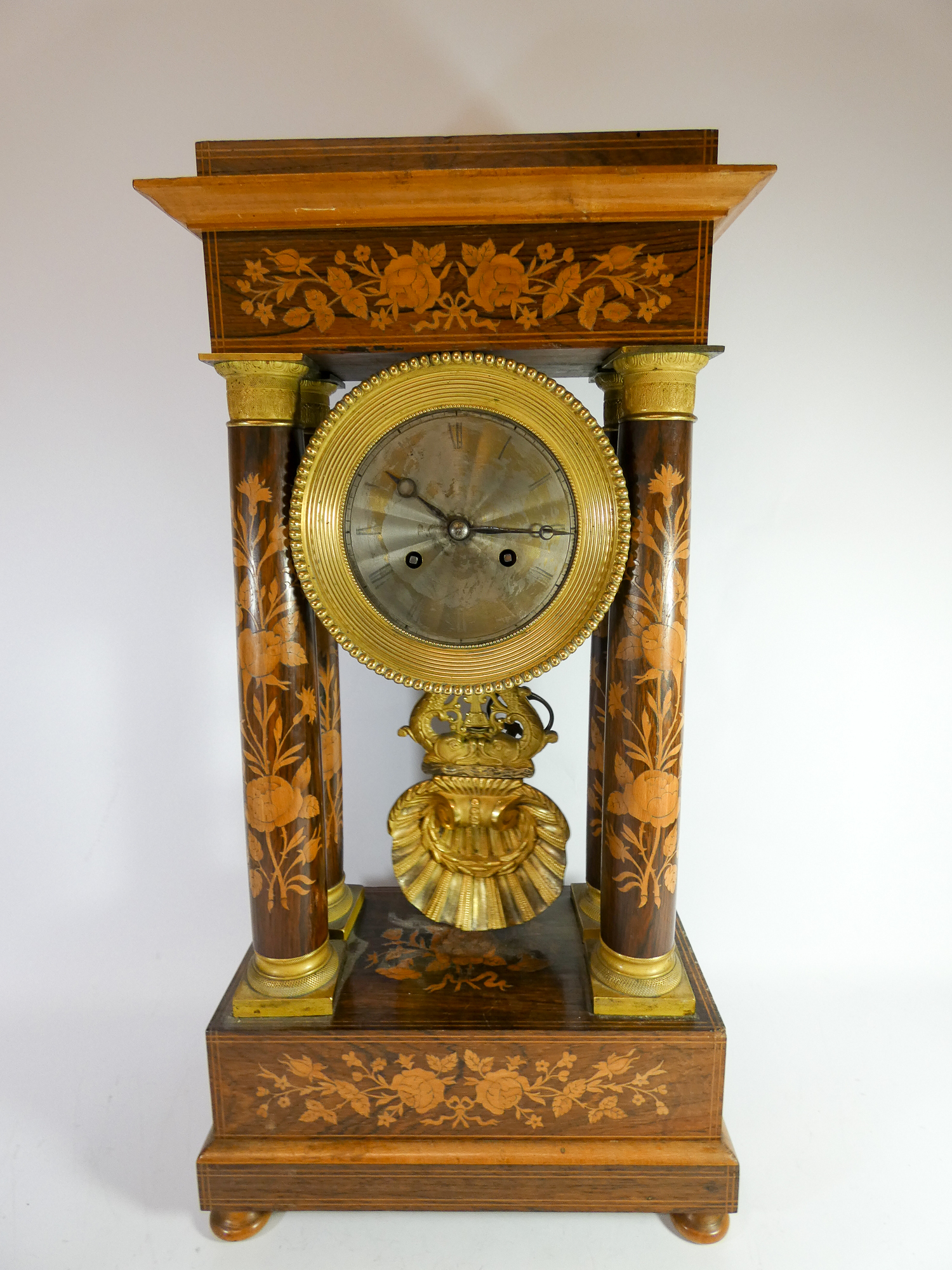 A Regency inlaid rosewood portico clock with brass bezel,