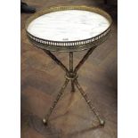 A circular brass framed wine table with gallery top and inset with white marble