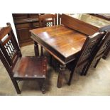 A Jali hardwood dining table with iron studs and six matching chairs with decorative iron panel