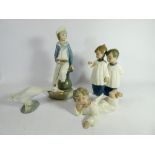 A collection of four Lladro and Nao figurines the largest of which measures 24cm