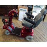 A Similar Rascal four wheel mobility scooter in a red case in good condition