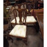 A set of eight Queen Anne style mahogany dining room chairs standing on cabriole legs with cream