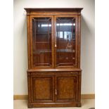 A Brights of Nettlebed Victorian style figured walnut two door glazed bookcase,