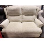 A modern two reclining seater settee in pale green mottled material