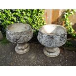 Two circular garden reconstituted stone planters on base, one as found,