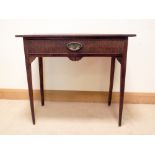 A Georgian oak hall table fitted one long drawer with brass handle standing on shaped taper legs,