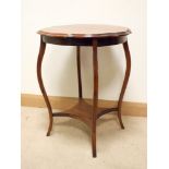 An Edwardian circular mahogany two tier occasional table