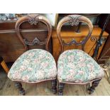 A pair of Victorian mahogany balloon back dining chairs with tapestry upholstered seats