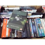 A large box of mostly box set DVDs