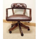 A mahogany framed brown leather upholstered, swivel, sprung framed,