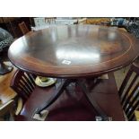 A circular reproduction mahogany coffee table on pillar base