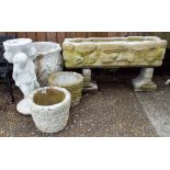 A reconstituted stone trough shaped planter, a circular planter,