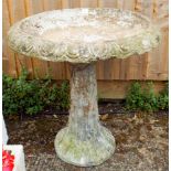 A large reconstituted stone garden bird bath on pillar base