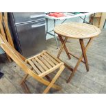 A hardwood folding garden circular bistro table with three matching chairs