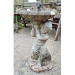 A reconstituted stone garden bird bath with young child base