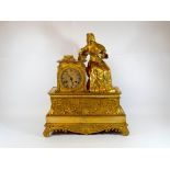 A French gilt bronze figure mounted mantel clock decorated with an 18th Century style seated lady,