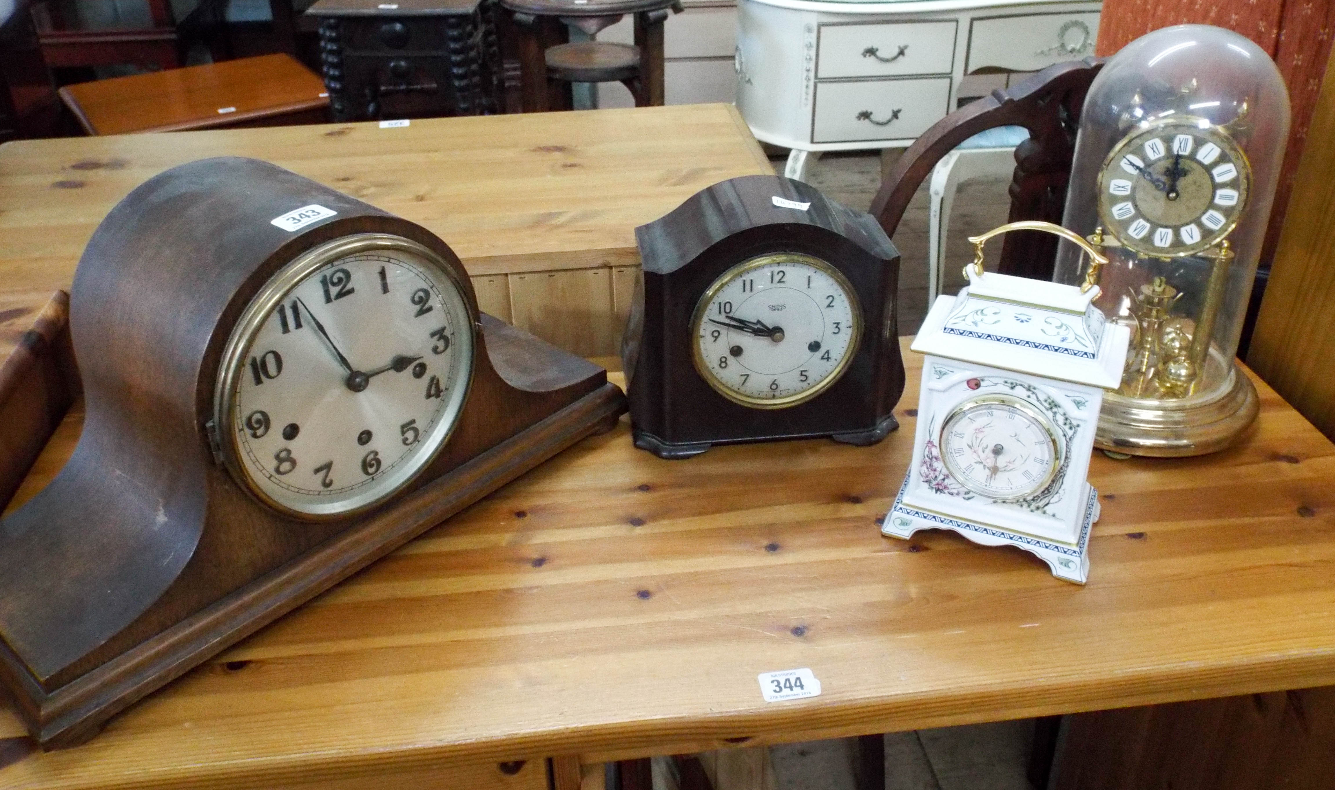 A collection of clocks to include anniversary clock beneath dome,