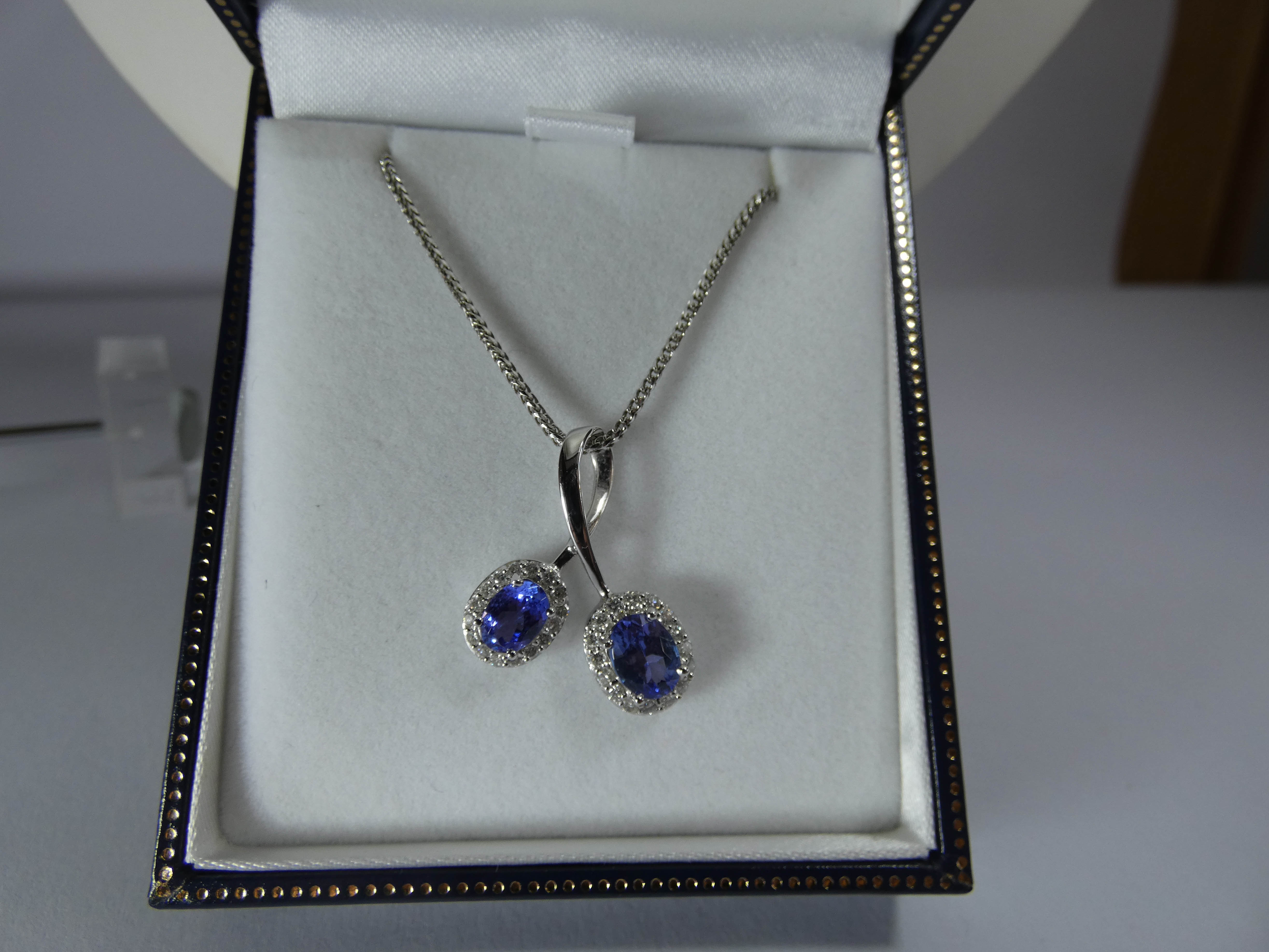 Modern 18ct white gold tanzanite and diamond cluster cross over design pendent on bright cut link - Image 3 of 4