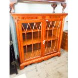 A burr yew astragal glazed two door bookcase