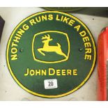 A circular John Deere advertising iron sign