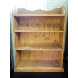 A wax pine bookcase with fixed shelves