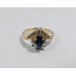 A ladies sapphire and diamond dress ring set with an oval sapphire and channel set and claw set