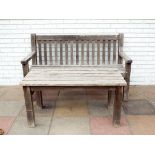 A teak garden bench seat with matching slatted coffee table