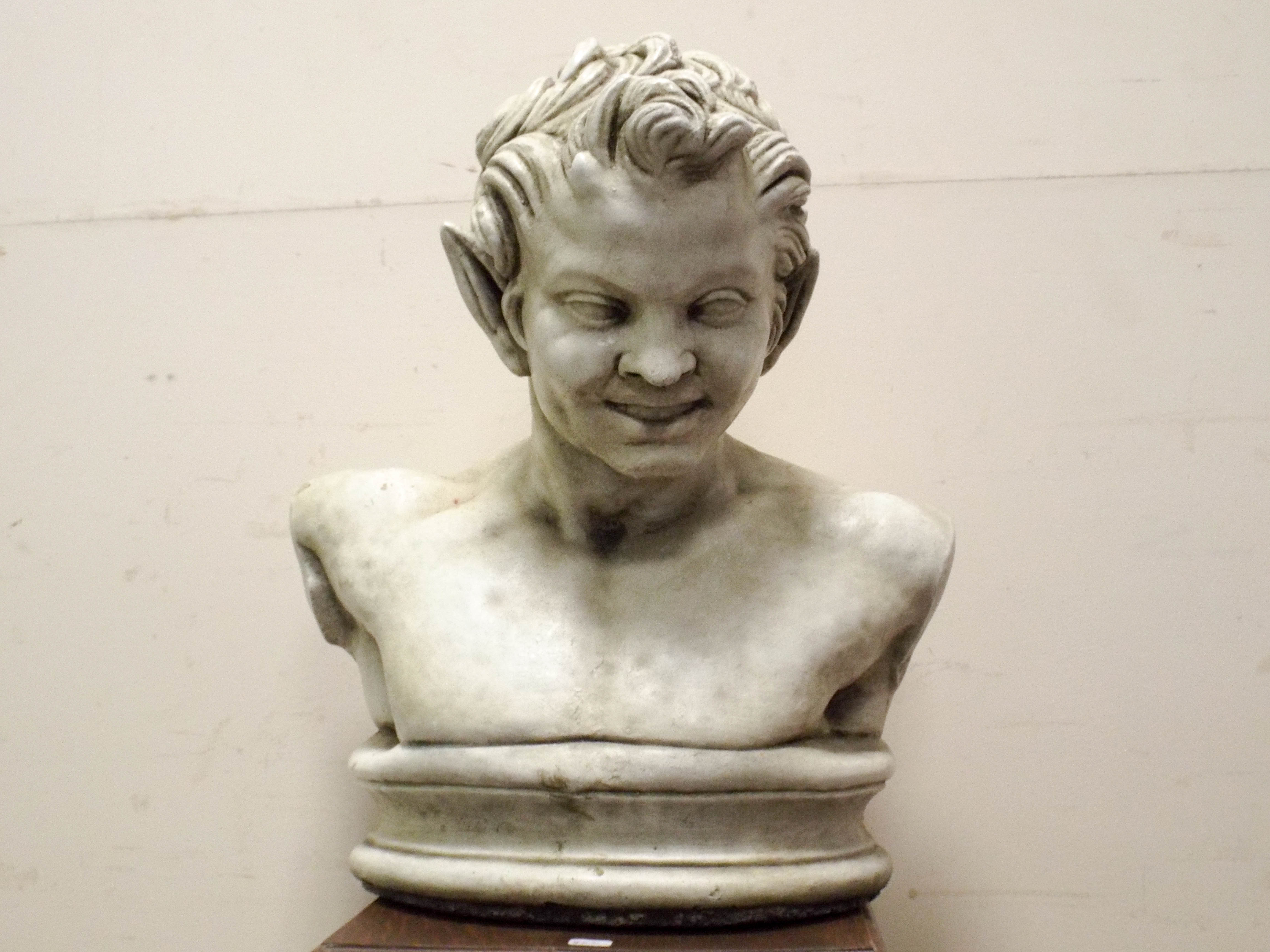 A reconstituted stone bust of Pan