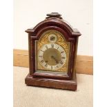 An Edwardian striking bracket clock with brass and silver arched dial in mahogany case with