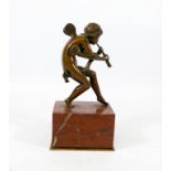 A 19th century bronze figure of a cherub pipe player resting on a rouge marble and gilt metal