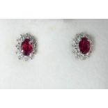 A pair of 18 ct white gold ruby and diamond cluster earrings with a copy of insurance valuation