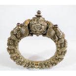 A 19th century Chinese silver bangle modelled as two beaked serpents holding a ball,