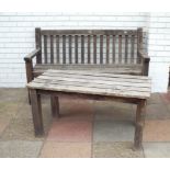 A teak garden bench seat with matching slatted coffee table