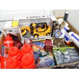 A large box containing a water pump, meerkat toy, water bottles, Wii games, pencils,