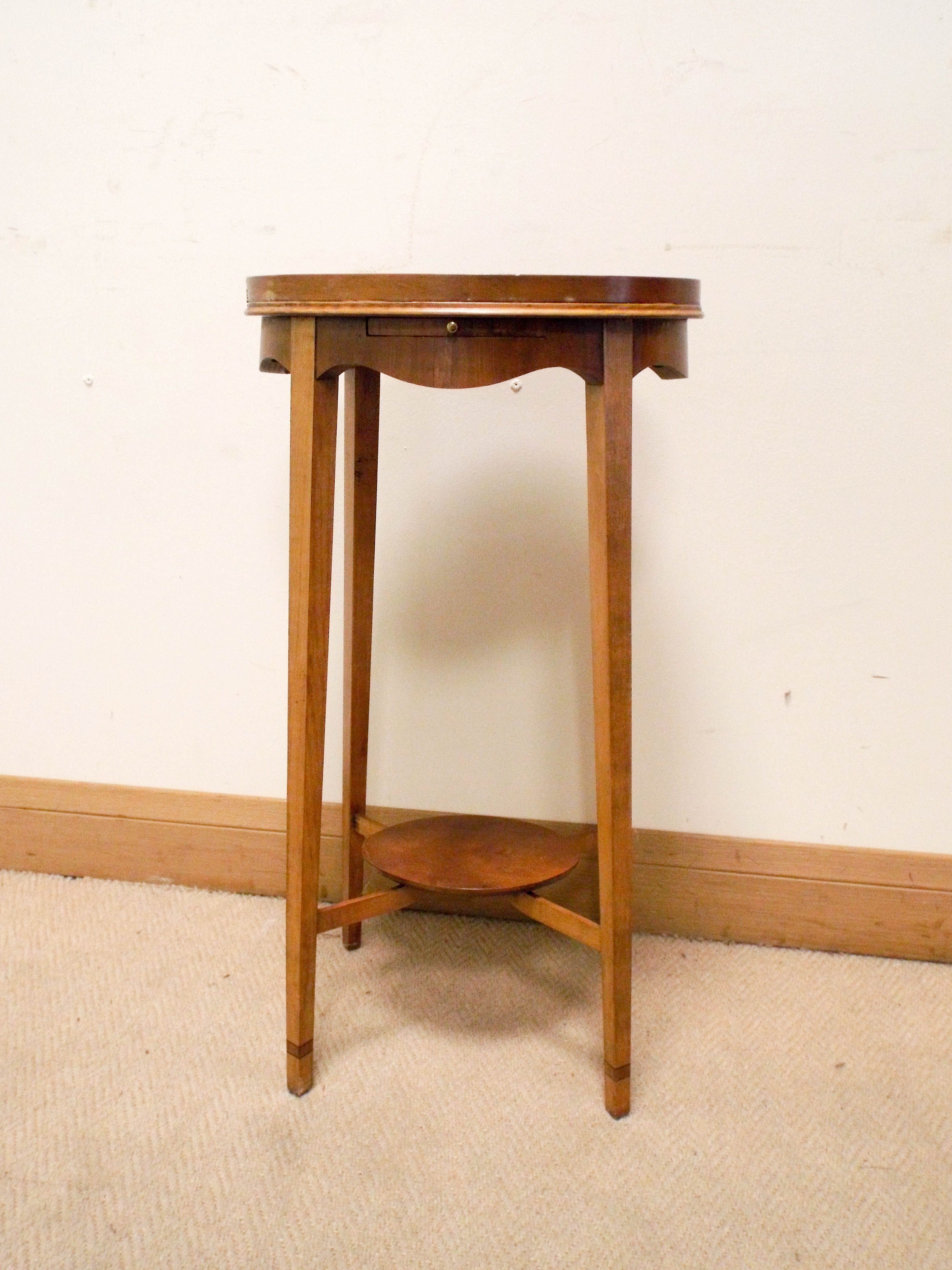 An oval satinwood shell inlaid two tier lamp table with pullout slide, 13" x 10.