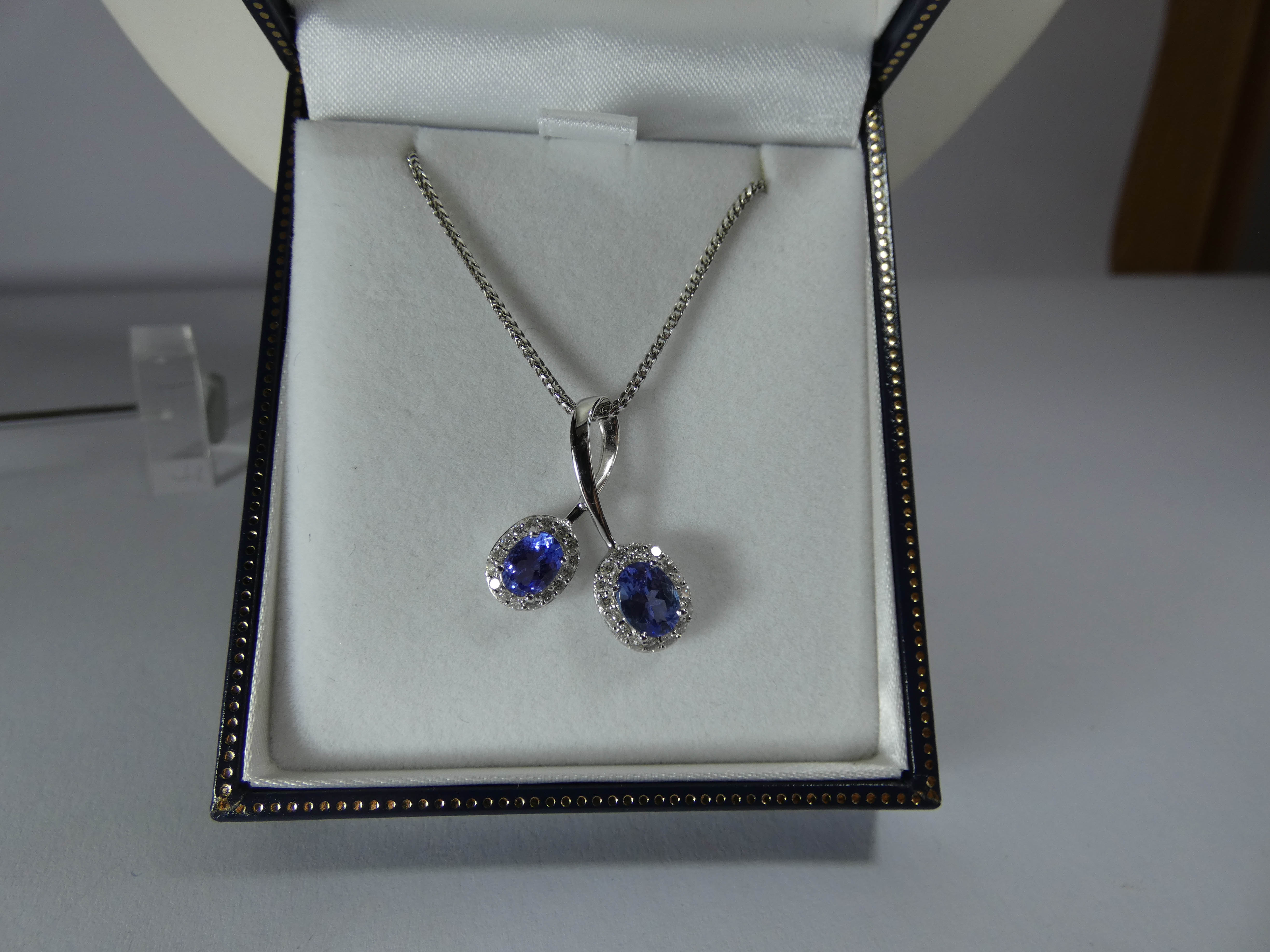 Modern 18ct white gold tanzanite and diamond cluster cross over design pendent on bright cut link - Image 4 of 4