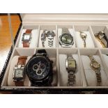 Sixteen assorted ladies and gent's watches in display case