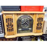 A radio cassette player with record deck in an old style wooden case