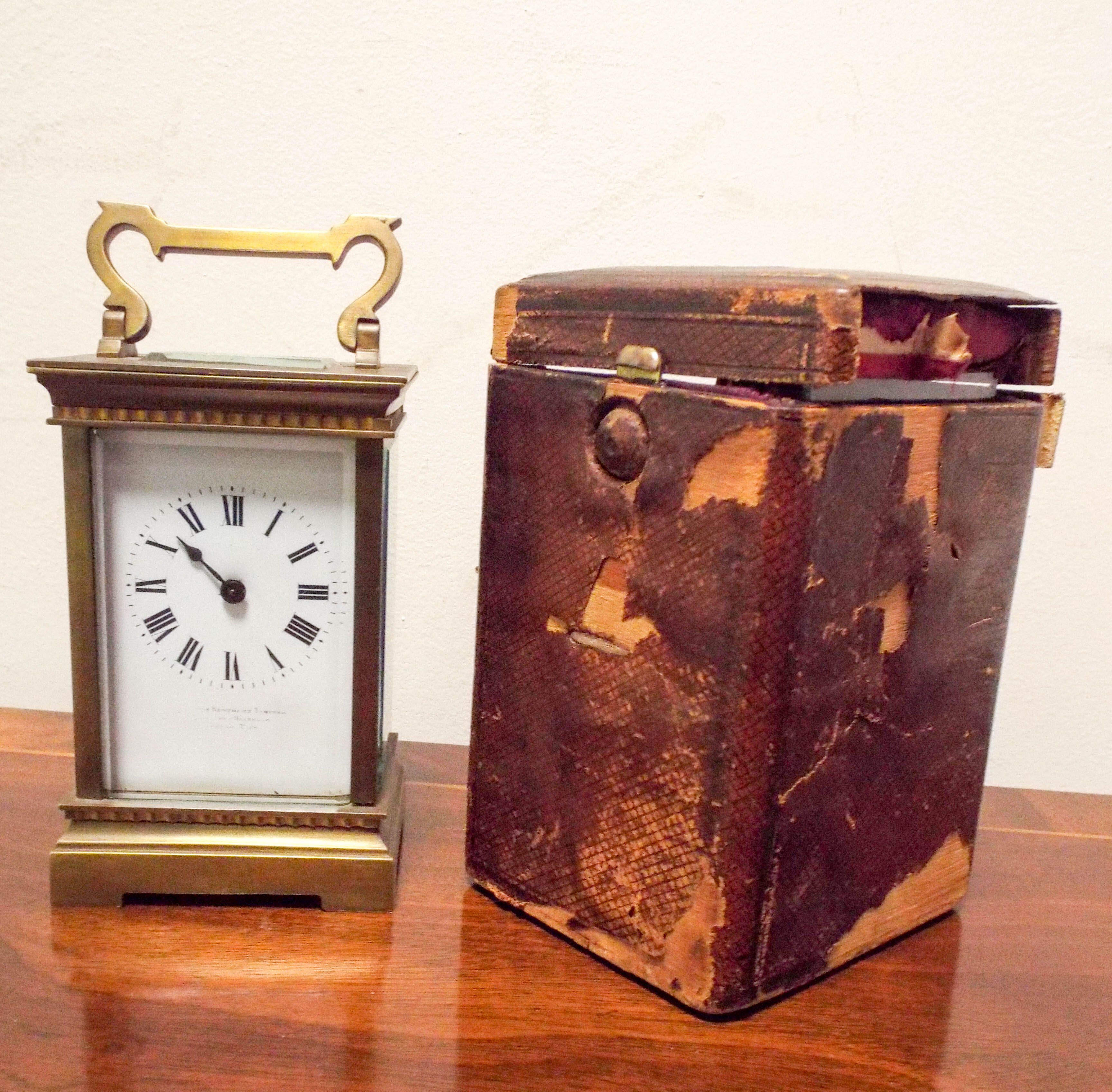 A late Victorian brass carriage clock with leather travelling case