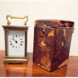 A late Victorian brass carriage clock with leather travelling case