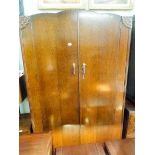 A 1930's oak three piece bedroom suite comprising of a large double door wardrobe,