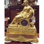 A French gilt bronze empire style table clock modeled as a classical lady seated in a chair,
