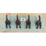 Four dog tail coat hooks on marble base