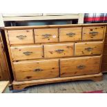 A varnished pine combination chest of nine drawers