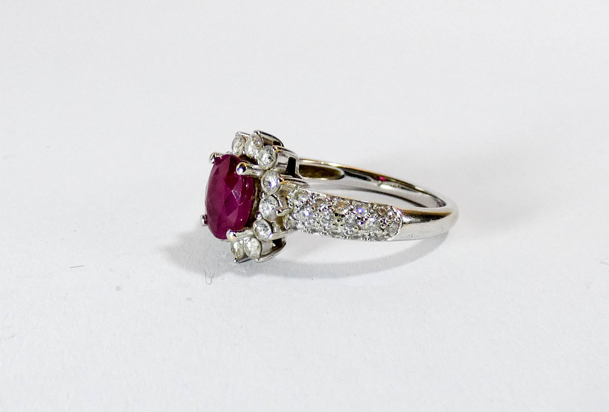 A 14ct white gold ruby and diamond cluster ring set with an oval ruby surrounded by brilliant cut - Image 2 of 3